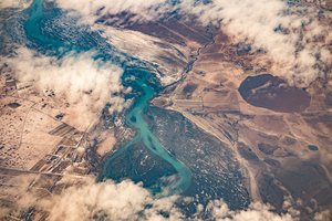Aerial view of Höfn showcasing a winding river surrounded by lush land and scenic landscapes